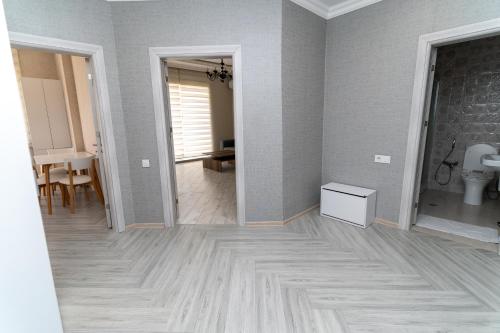 an empty room with a toilet and a hallway at Rest House in İsmayıllı