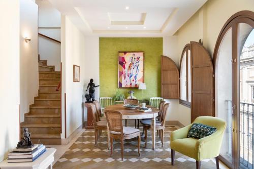 - une salle à manger avec une table et des chaises dans l'établissement Magno Apartments Santo Tomas, à Séville