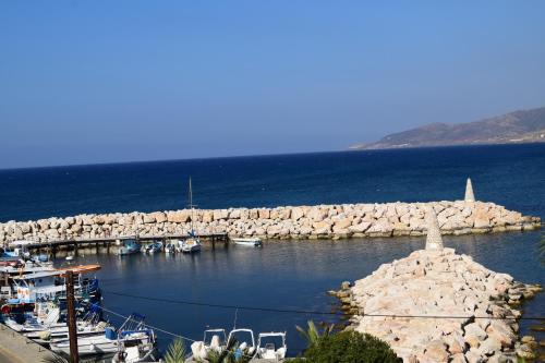 a group of boats docked at a dock in the water at Kanalli Apartments in Pomos