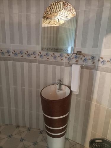 a bathroom with a sink and a mirror at OLOIRIEN HOTEL & RESORT in Narok