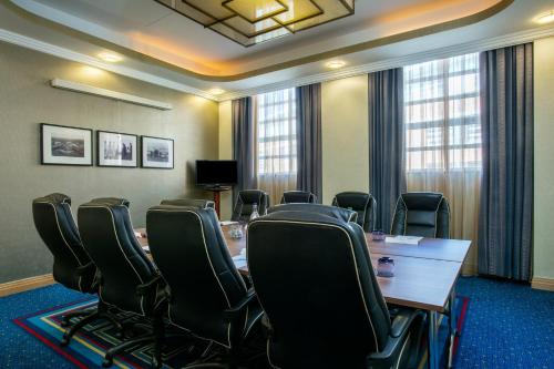 a conference room with a long table and chairs at Crowne Plaza Liverpool - John Lennon Airport by IHG in Liverpool