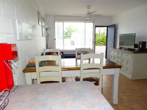a kitchen with a table and chairs in a kitchen at Baccarat in Port Vincent