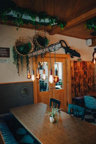 a dining room with a table and chairs and lights at Johnys Jungle in Marbach an der Donau