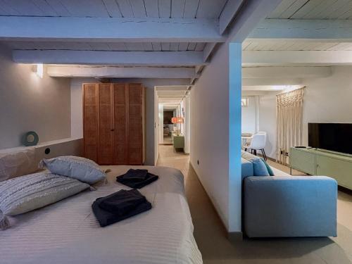 a bedroom with a large bed with two pillows on it at Prédio da Estação in Porto