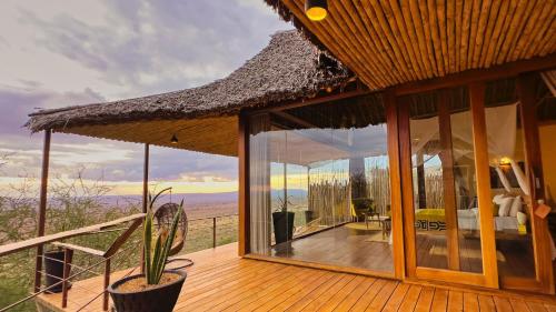 a house with a balcony with a view of the desert at Soroi Lions Bluff Lodge in Mwanda
