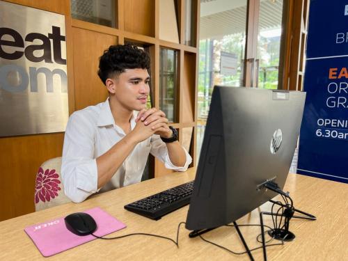 a man sitting at a desk in front of a computer at Holiday Inn Express Phuket Patong Beach Central by IHG in Patong Beach