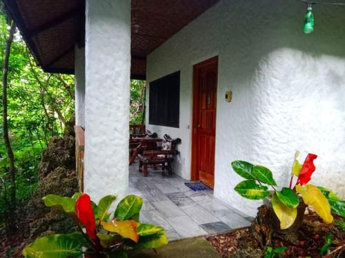 a front porch of a house with a red door at Kim's Garden in Anda
