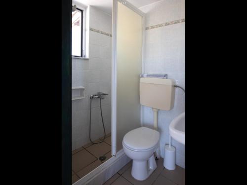 a bathroom with a toilet and a sink at Papoulias Rooms in Elafonisos