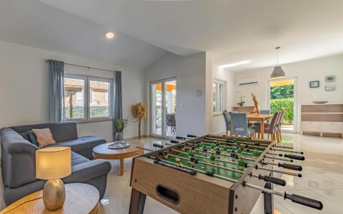 a living room with a foosball table at Lotus Villas Resort in Pula