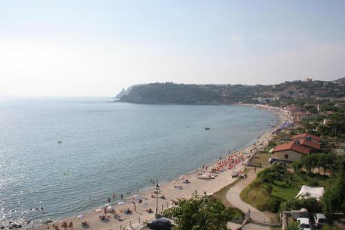 a beach with a bunch of people and the ocean at Le Casette Sul Mare in Capo Vaticano