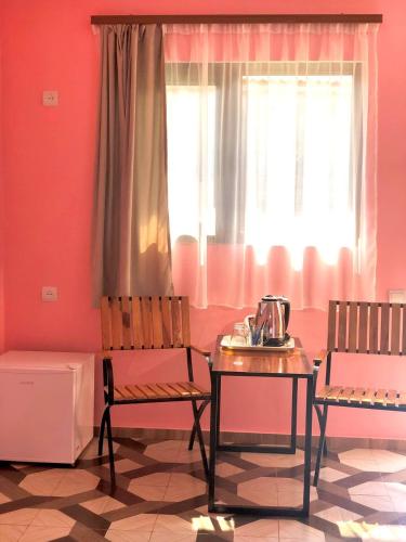 a room with two chairs and a table and a window at VaLiVa Sanahin Guest House in Sanain