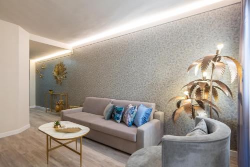 a living room with a couch and a table at Hotel Palacete de Alamos in Málaga
