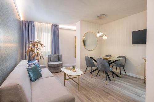 a living room with a couch and a table at Hotel Palacete de Alamos in Málaga