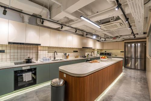 a large kitchen with a large island in the middle at Weave Suites - Midtown in Singapore