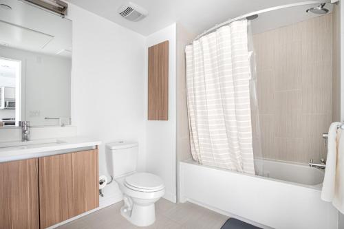 a bathroom with a toilet and a tub and a sink at Campbell 1BR w Pool Parking nr Groceries SFO-441 in Campbell
