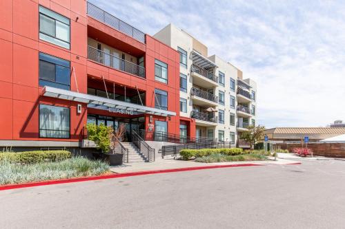a red building with a parking lot in front of it at Campbell 1BR w Pool Parking nr Groceries SFO-441 in Campbell