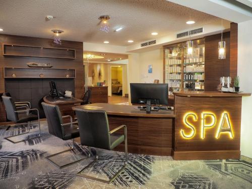 an office with a spa sign on a desk at Wellness & Naturresort Reischlhof in Wegscheid