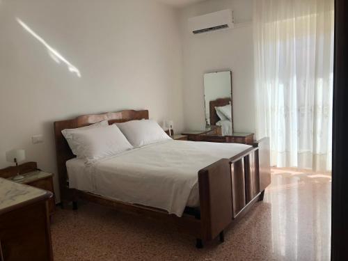 a bedroom with a large bed and a mirror at Regina in Ortona