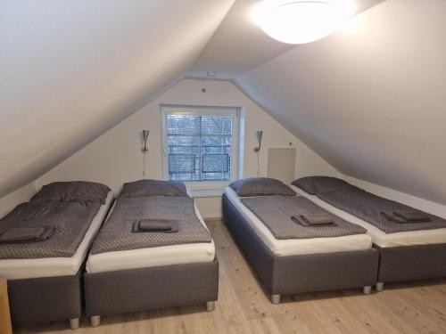 two beds in a room with a attic at Apartmá SunGarden Liberec in Liberec