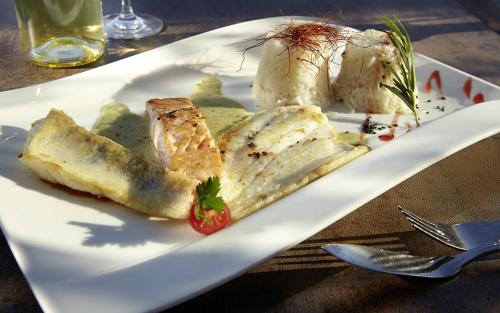 a white plate with food on a table at Hotel Villa am Rhein in Andernach