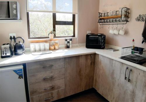 a kitchen with a sink and a counter top at Waterside Cottages & Villas - Self Catering in Gaborone