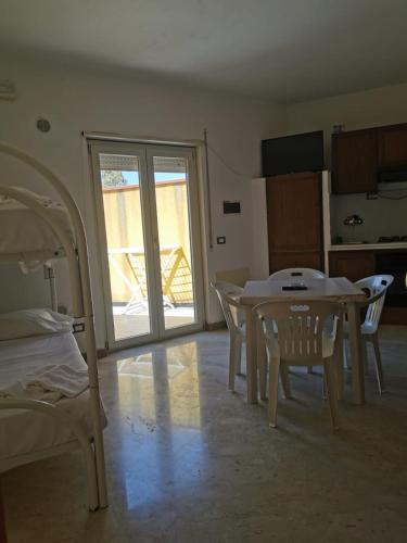 a room with a table and chairs and a dining room at Cala San Giorgio Residence in Sciacca