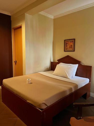 a bed with a cup sitting on top of it at Blue Velvet Hotel -CM Recto in Davao City