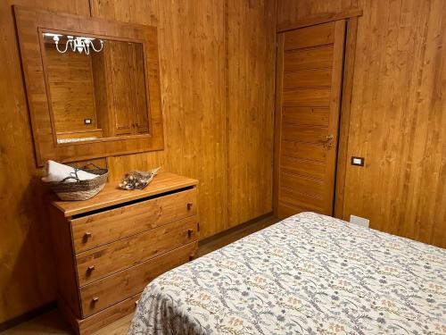 a bedroom with a bed and a dresser and a cabinet at Luxury Suite Terminillo in Terminillo