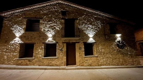 a stone building with lights on it at night at APARTAMENTOS AREKORATAS 255 y 256 in Muro de Ágreda