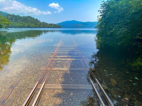 a river with train tracks in the water at Shikaribetsu Kohan Onsen Hotel Fusui in Shikaoi