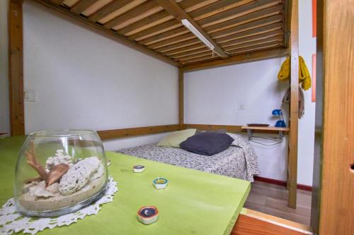 a room with a bed and a fish bowl on a table at Studio Plaza Farray in Las Palmas de Gran Canaria
