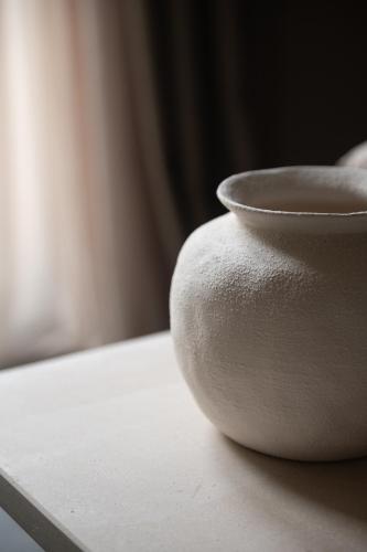 a white vase sitting on top of a table at The Sanctuary Urban Retreat in Rome