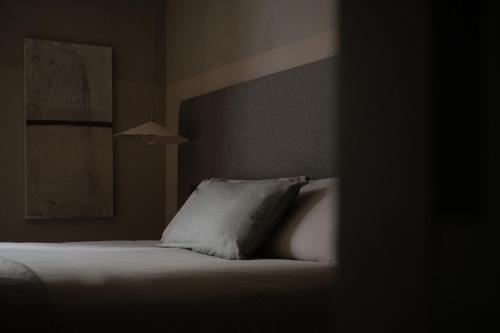 a bedroom with a bed with white pillows at The Sanctuary Urban Retreat in Rome