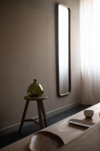 a table with a vase on it next to a window at The Sanctuary Urban Retreat in Rome