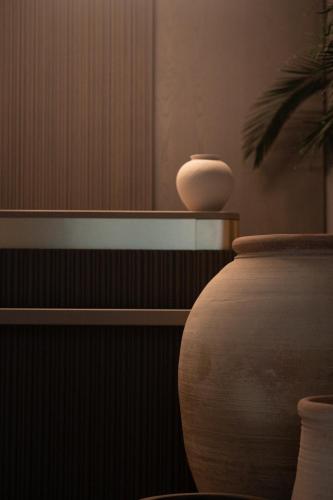 a vase sitting on top of a shelf in a room at The Sanctuary Urban Retreat in Rome