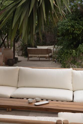 a white couch sitting on top of a wooden table at The Sanctuary Urban Retreat in Rome
