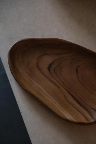a wooden bowl sitting on top of a table at The Sanctuary Urban Retreat in Rome