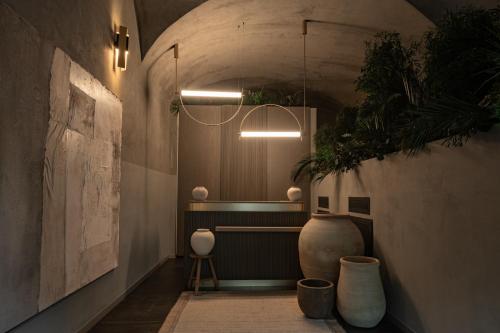 a hallway with a large vase and a light fixture at The Sanctuary Urban Retreat in Rome