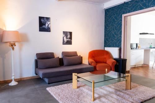 a living room with a couch and a glass coffee table at Find yourself apartment Dunkerque in Coudekerque-Branche