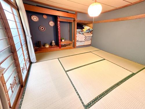 an empty room with a white rug on the floor at Cosmo St Inn Noboribetsu 3min walk from JR Noboribetsu st in Noboribetsu