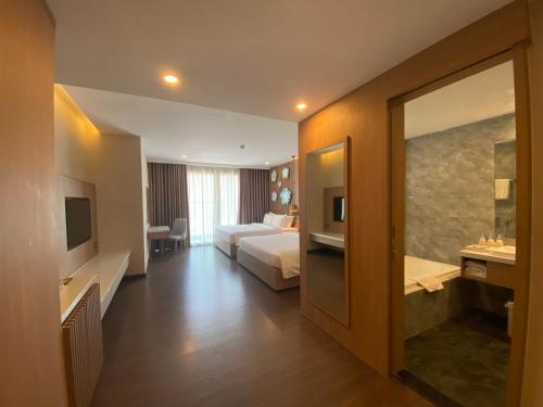 a hotel room with a bed and a bathroom at Virgo Hotel Nha Trang in Nha Trang