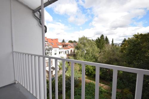 balkon z białą poręczą i niektóre budynki w obiekcie Air Apartments 3 w Bremie