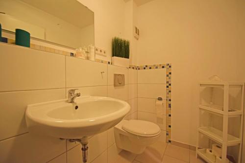 a bathroom with a sink and a toilet at Air Apartments 6 in Bremen