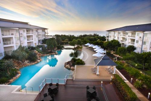 an overhead view of a pool at a resort at Quiet Apartment in Mantra Salt Beach by uHoliday - 2BR, 1BR and Hotel Room configurations available in Kingscliff