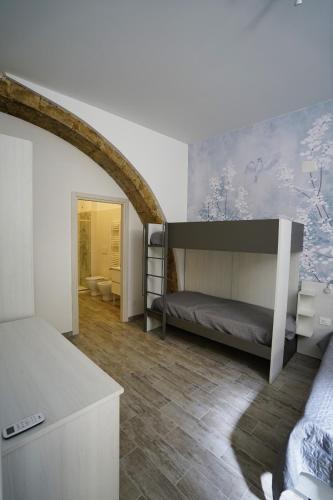 a bedroom with a bunk bed and a bathroom at CARLO DI BORBONE - Casa Vacanze- in Fornelli