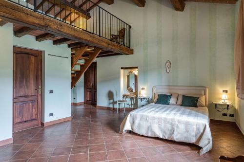 a bedroom with a bed in a room with a staircase at PODERE MONTIONI 6&2, Emma Villas in Rapolano Terme