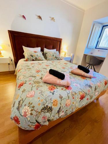 a bedroom with a bed with two towels on it at A Alma Portuguesa in Fátima