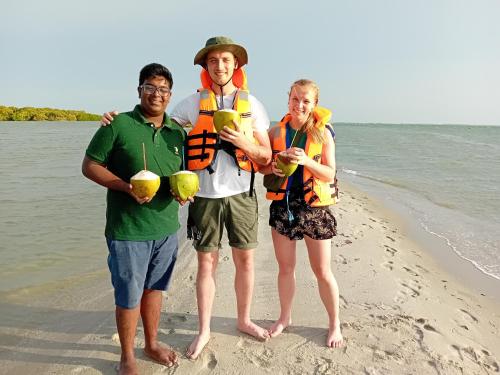 a group of three people standing on the beach at Gange Wadi Wilpattu in Gangewadiya