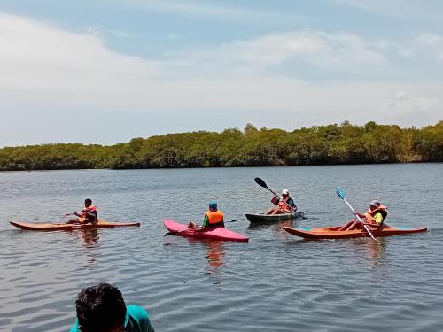 a group of people in kayaks on a lake at Gange Wadi Wilpattu in Gangewadiya