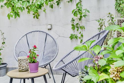 a pair of chairs and a table with plants at Buda Bliss Garden in Budapest